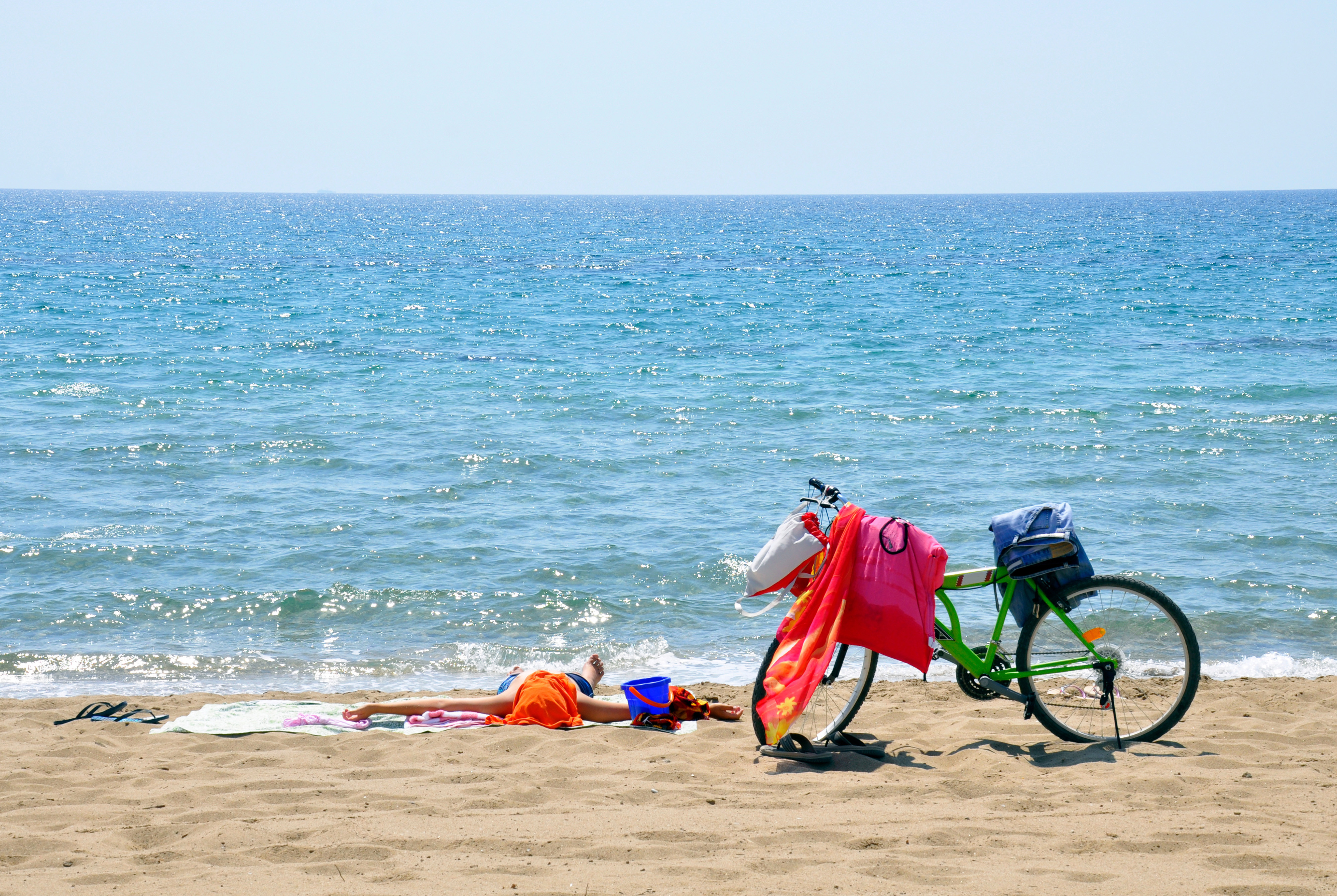 Taking a sunshine break on the beach after cycling